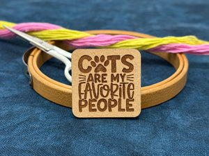 Photo of a needle minder that says, "Cats are my favorite people."