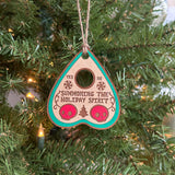 Hand-painted Summoning the Holiday Spirit Ouija Planchette Ornament hanging on a Christmas tree.