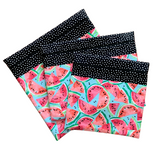 Fabric project bags with pink and coral watermelons on a blue background. Black with white dot accent fabric. Small, medium, and large sizes.